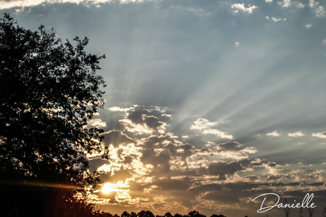 Sunset with rays through clouds and Danielle signature